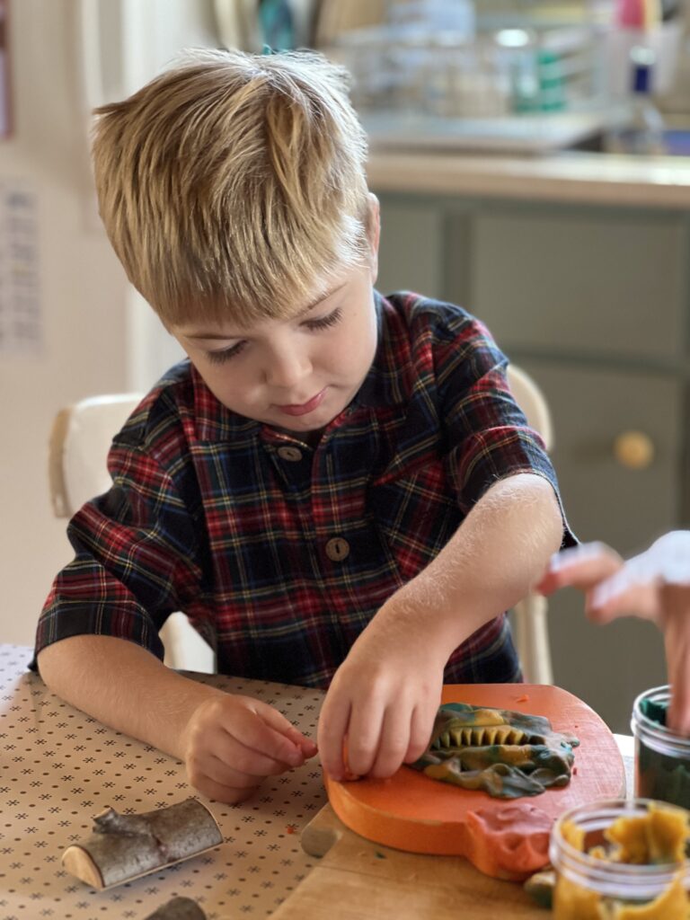 boy playing with fall playdough