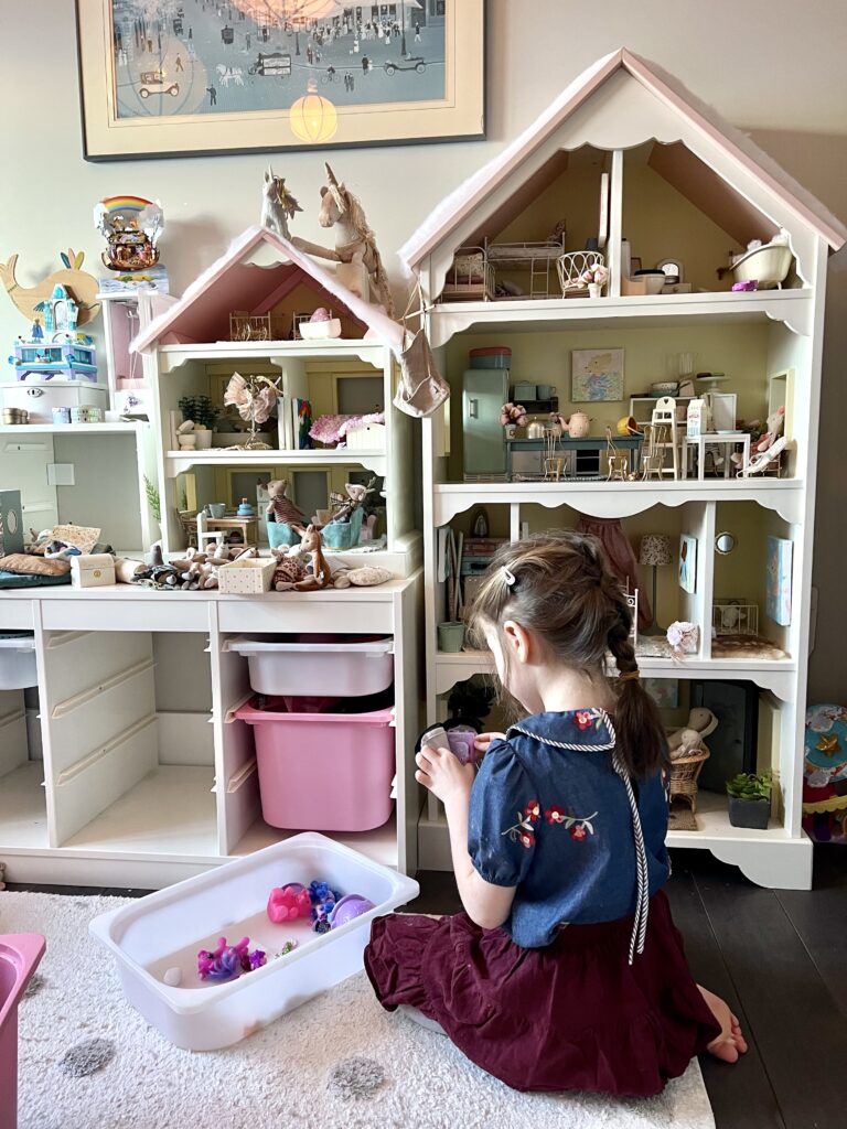 girl playing with Maileg dollhouse