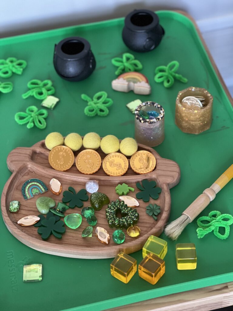 wood sensory tray with st. patrick's day trinkets, sensory invitation to play