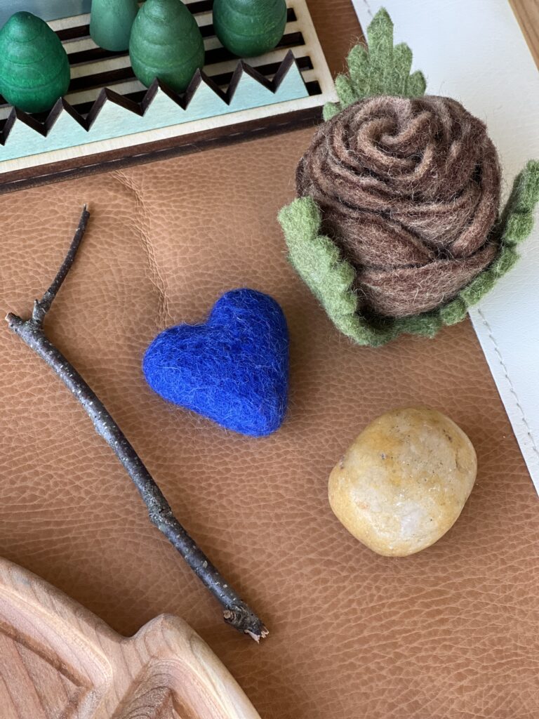 stick, stone, felt pinecone