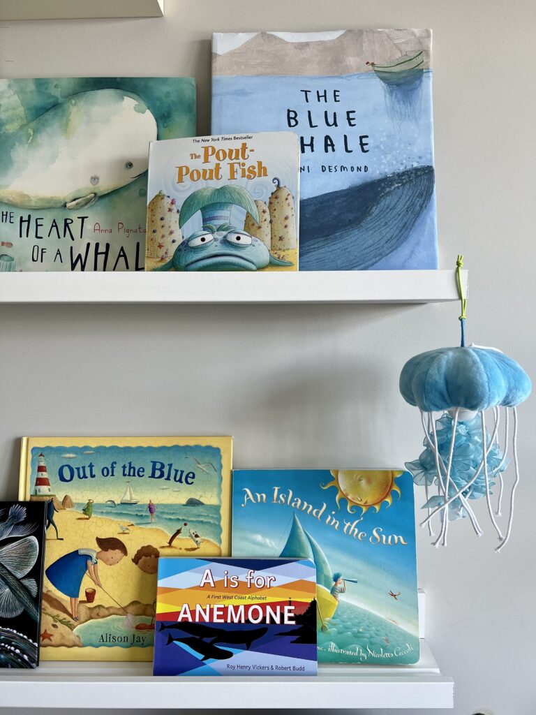 beach and whale children's books on shelf