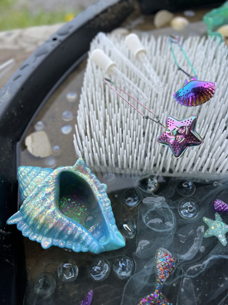 shell, droppers and tea tongs in fizzy play tray