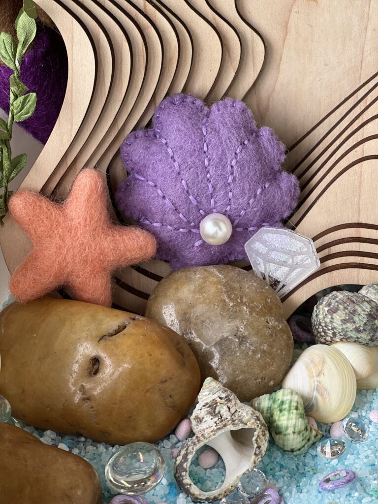 felt shell and star in sensory play