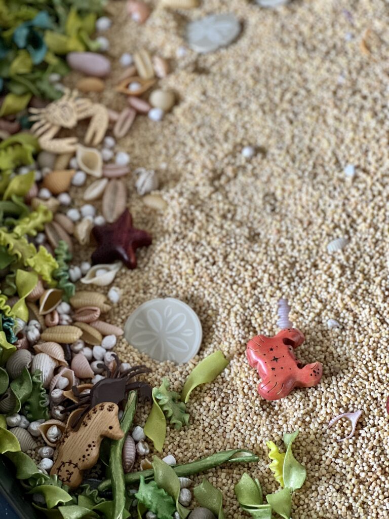 sensory play sand and wooden crab