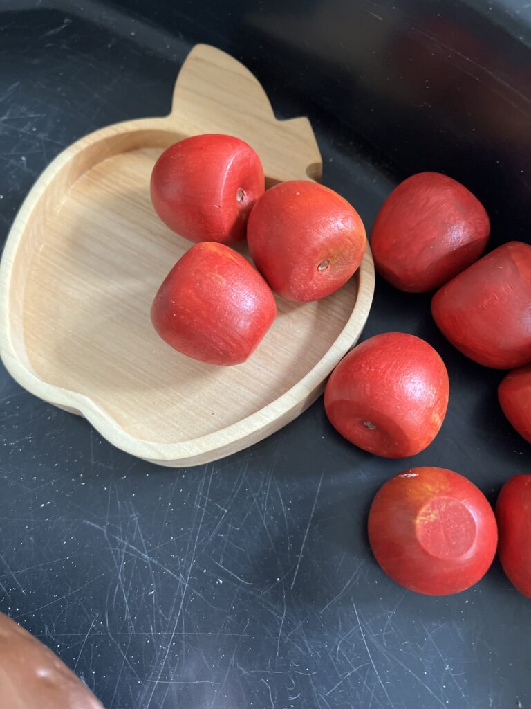 wooden apple counters in apple tray